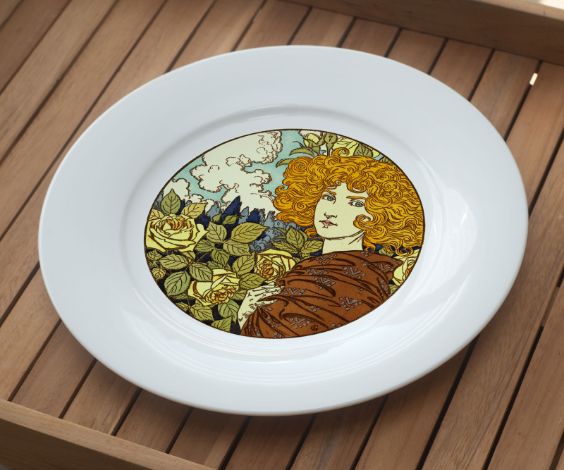White plate with an Art Nouveau-style illustration of a woman with curly hair and yellow roses