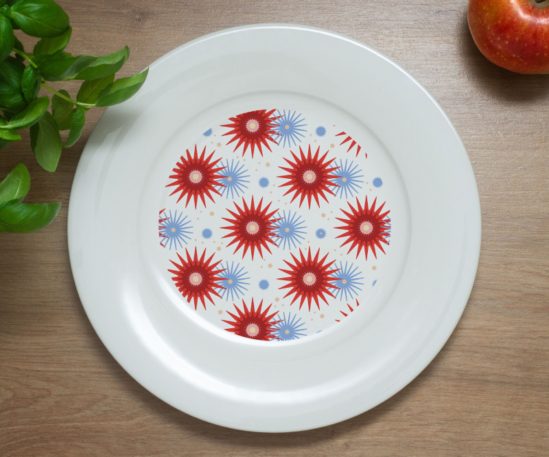 White plate with a colorful starburst floral pattern in red and blue