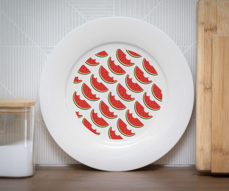 White plate with a repeating pattern of watermelon slices
