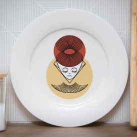 White plate with a stylized portrait of a woman with a red hair bun