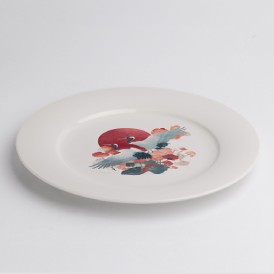 White plate with a Japanese-style illustration of a bird and red sun