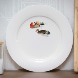 White plate with a vintage-style illustration of two ducks swimming