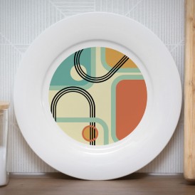 White plate with a retro geometric pattern in green, beige, black, and orange